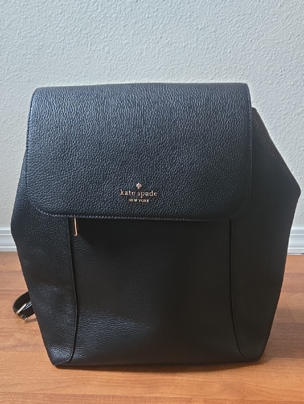 kate spade black pebbled leather flap backpack with gold logo